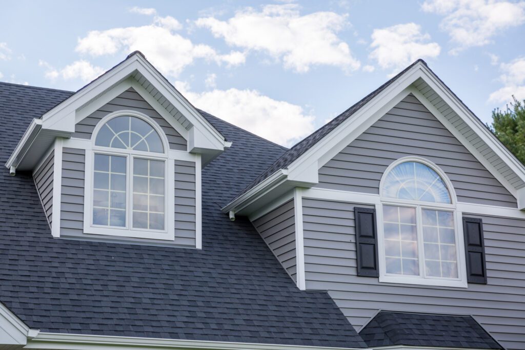 A house with gray siding and white windows to avoid window scams.