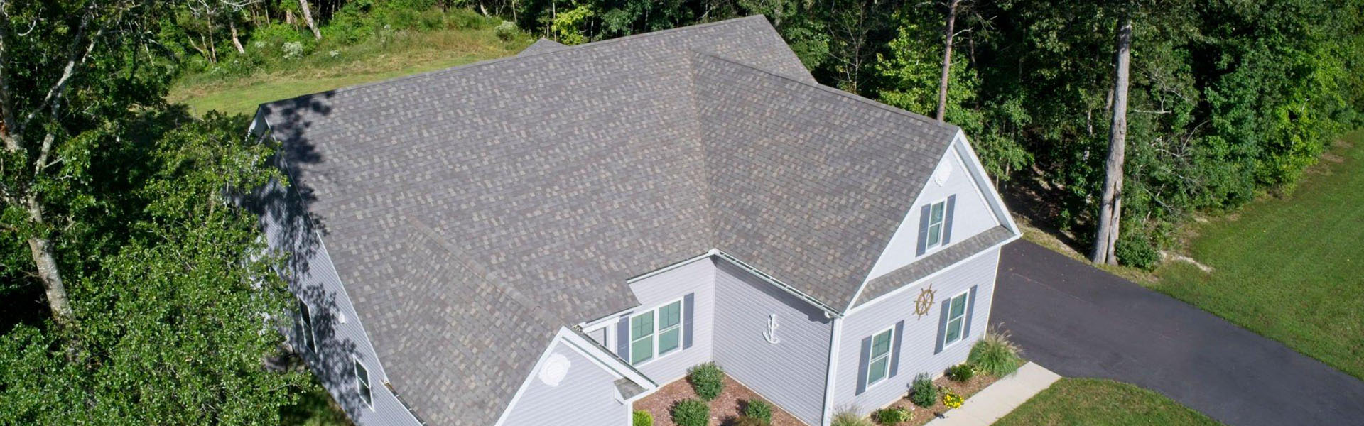 An aerial view of a home in the woods.