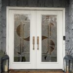A white front door with decorative glass panels.