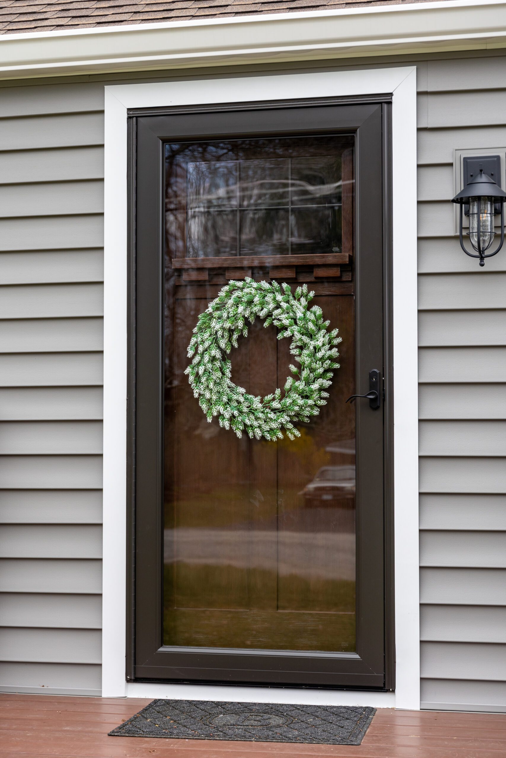A front door with a wreath on it.
