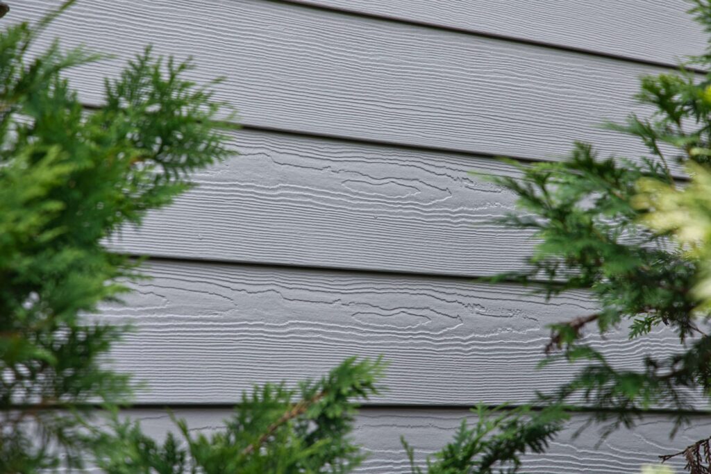 Siding contractor installs replacement siding