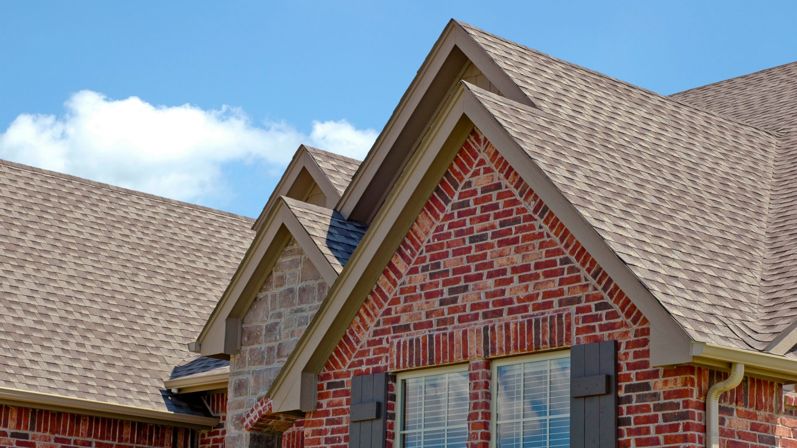 Closeup of a newly installed tan shingle roof