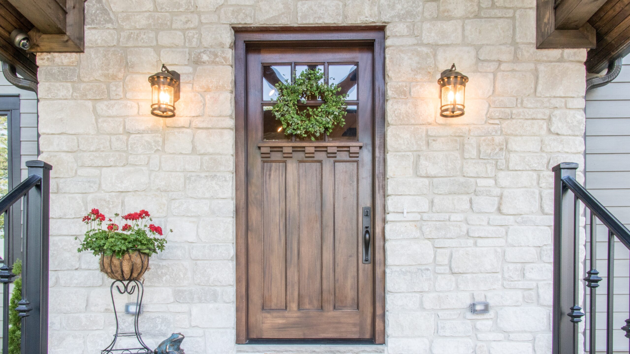 A stone home with a brown entry door