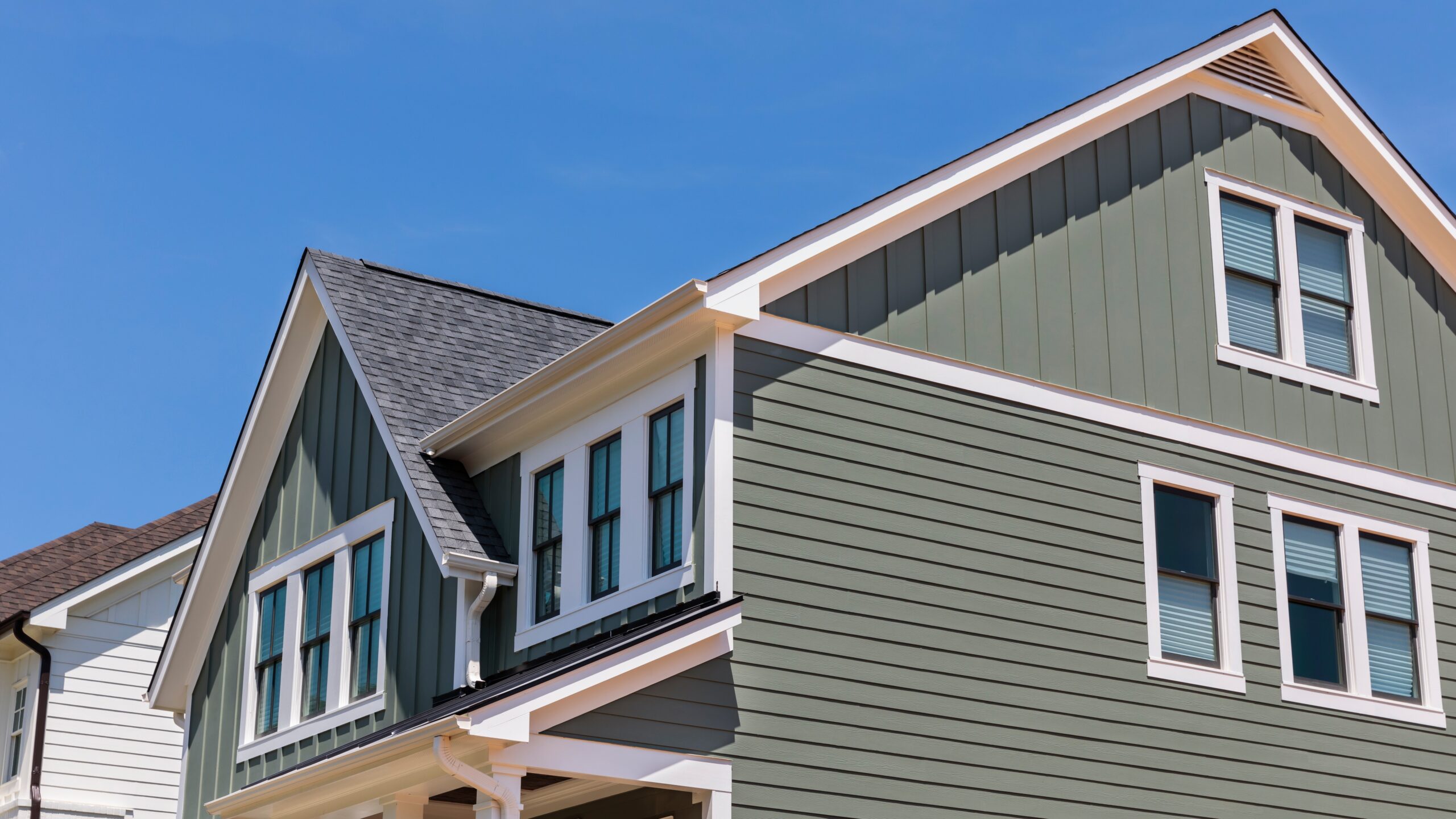 A home with green siding and white trim