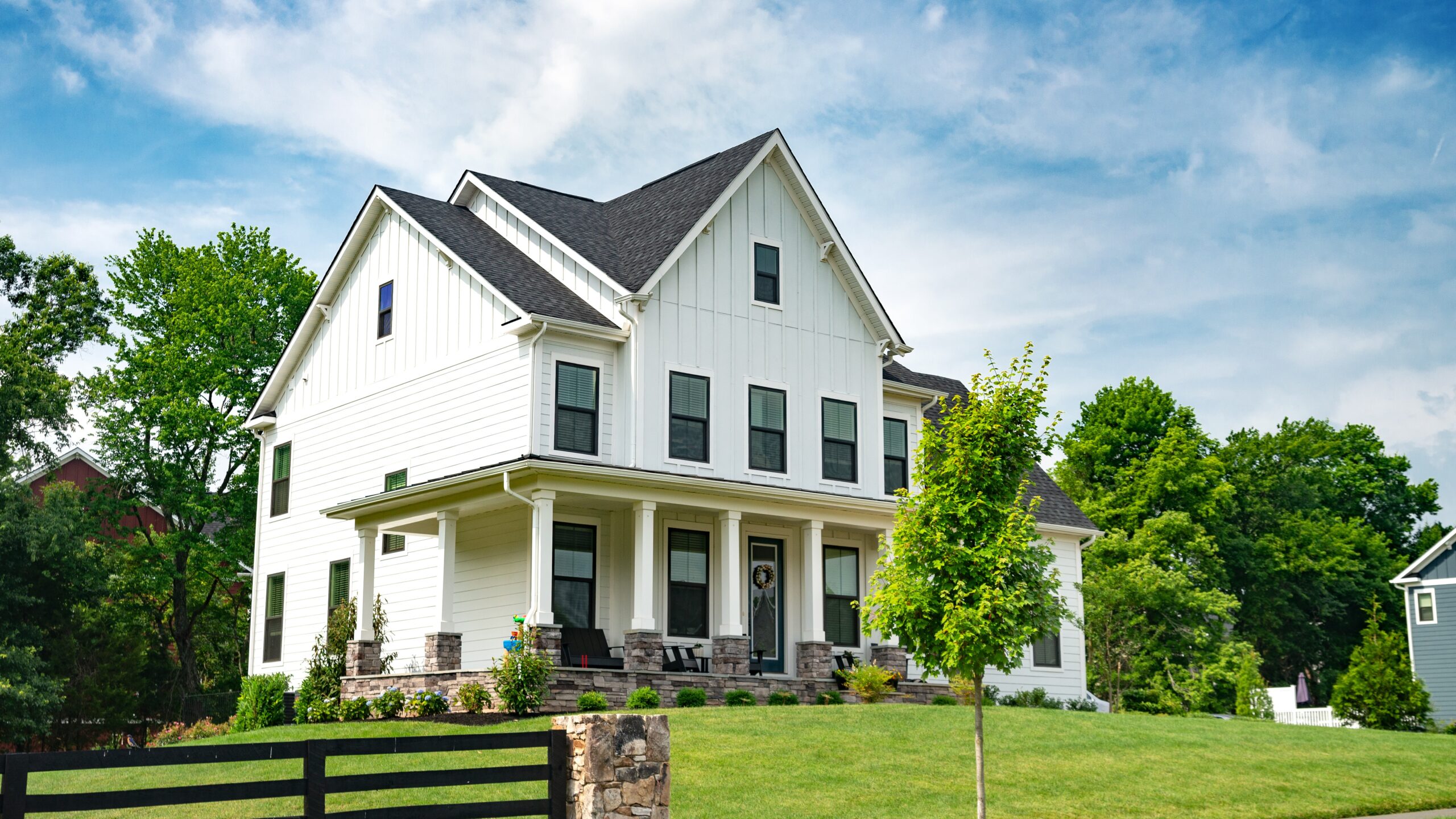 A white home with James Hardie siding and a gray shingle roof