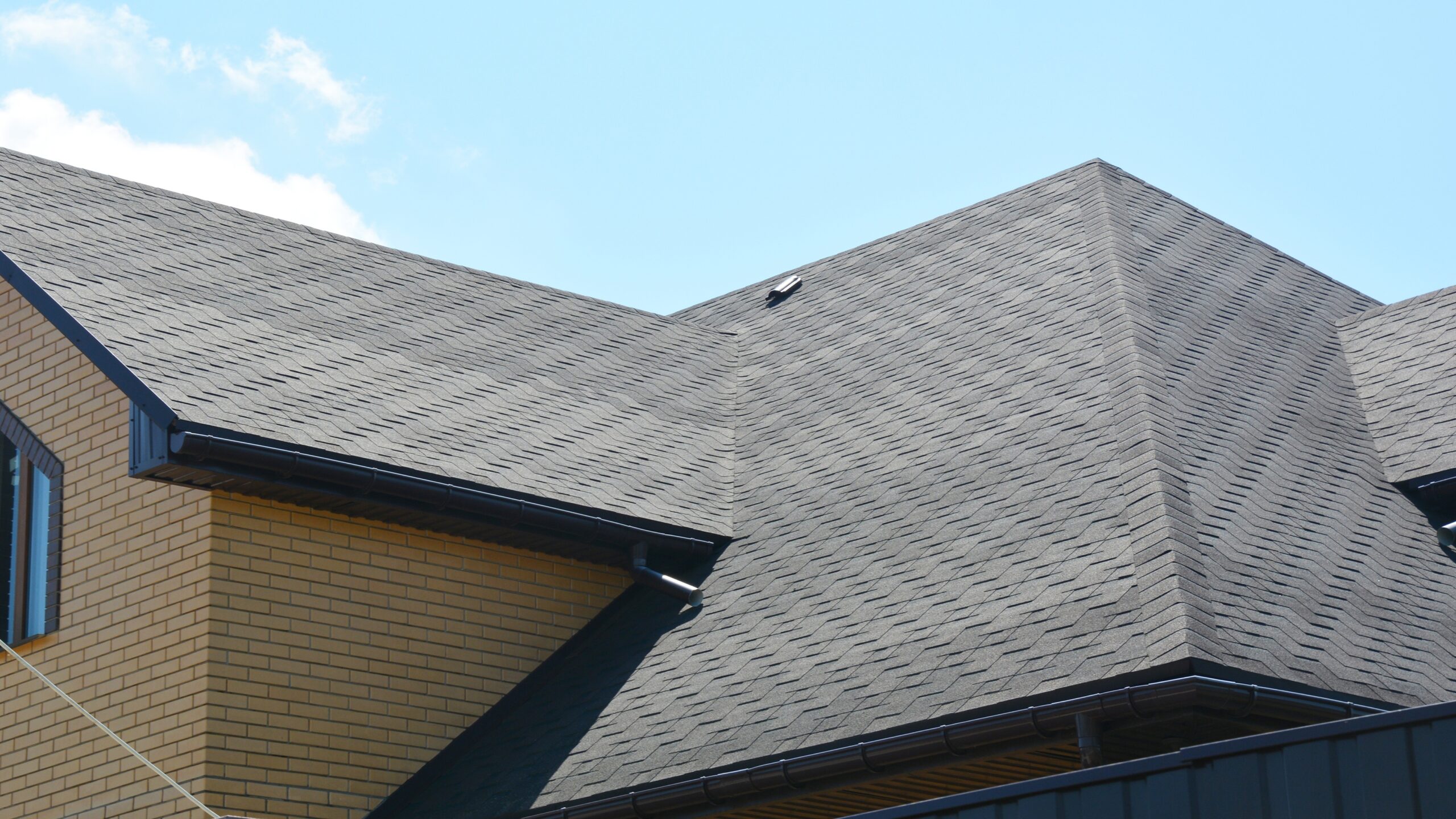 Closeup of a newly installed gray shingle roof