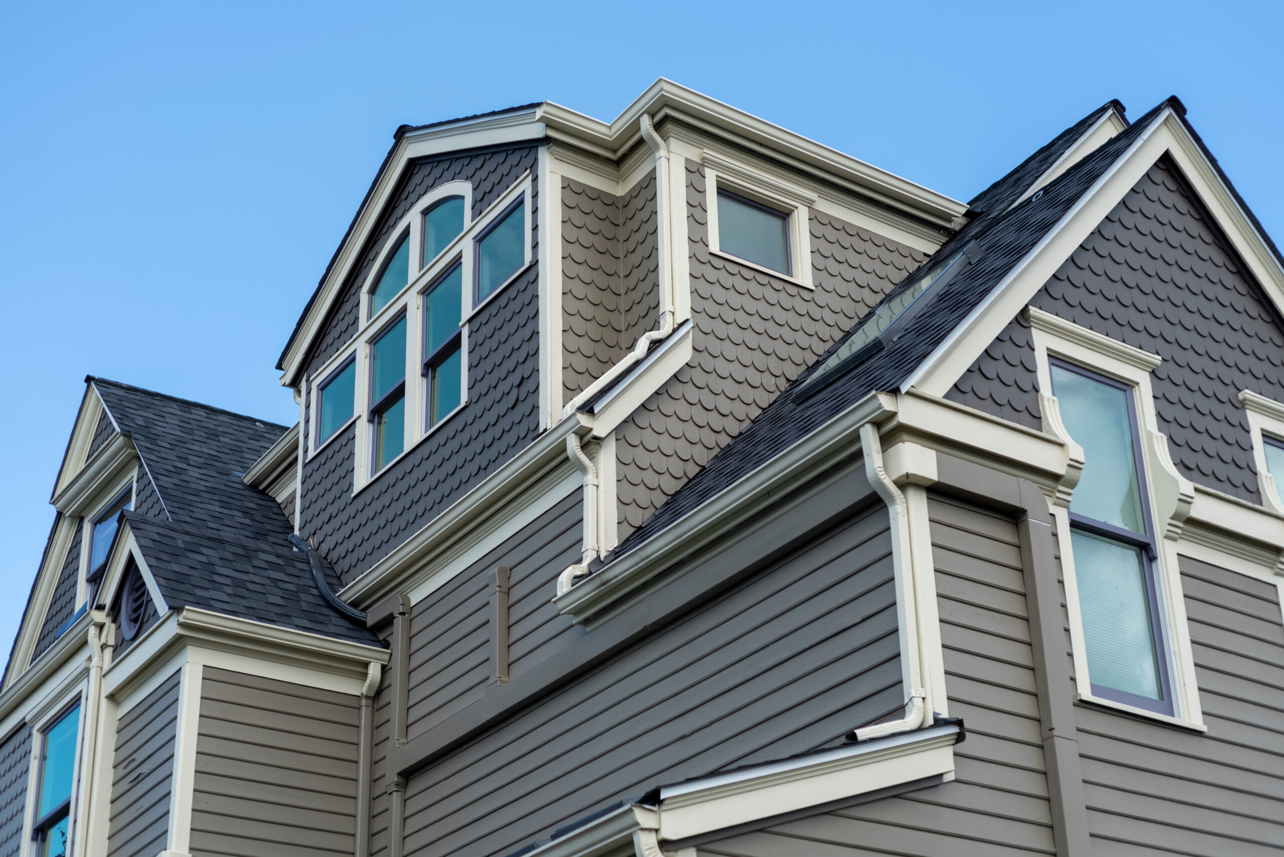 Gray siding house with new roof installed