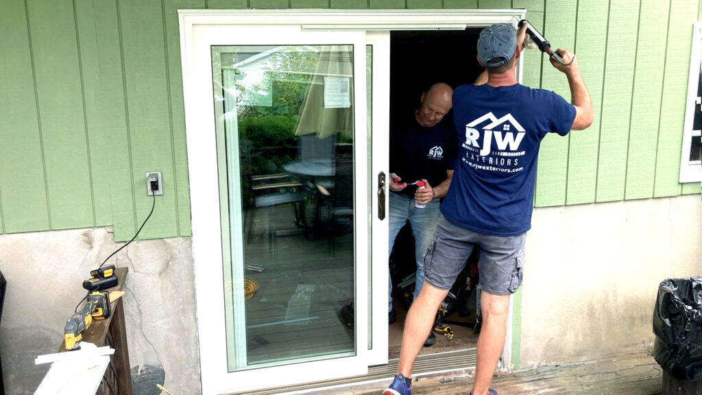 The RJW Exteriors team installs a brand-new patio door