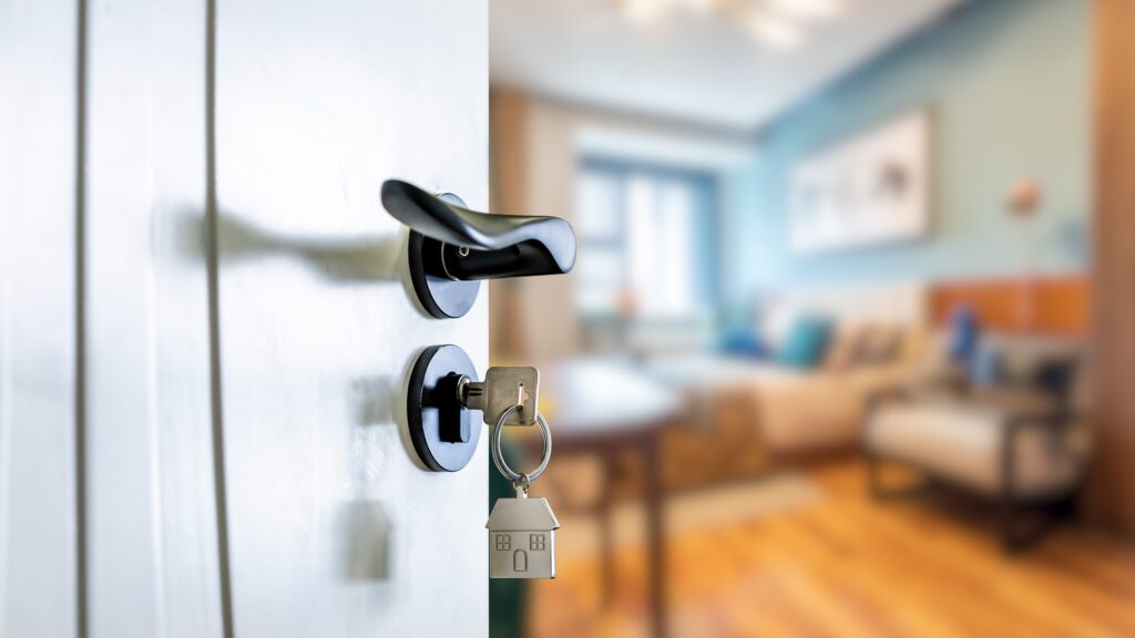 Close view of a partially open white front door with a custom curved detail