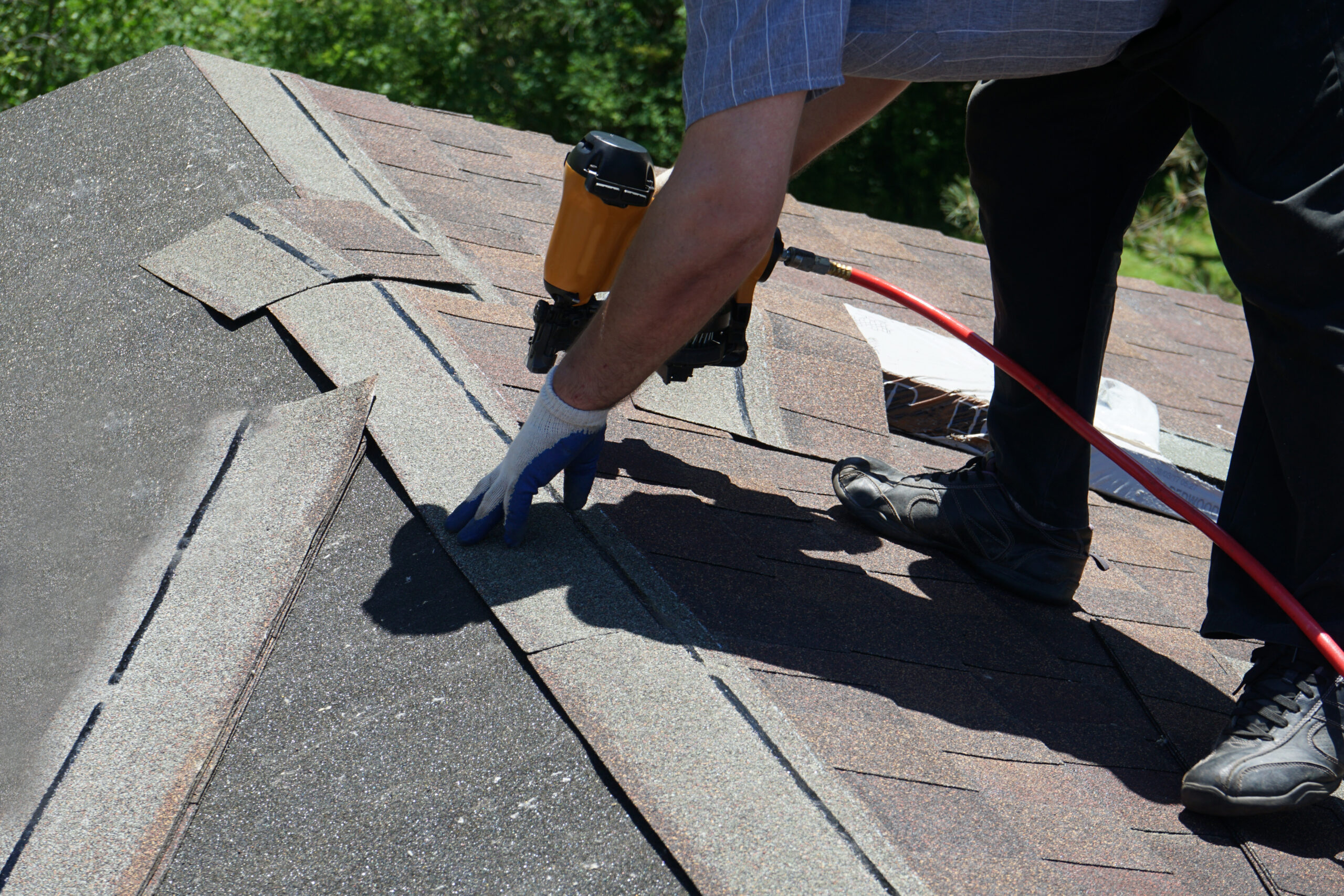 Asphalt roof being installed on house