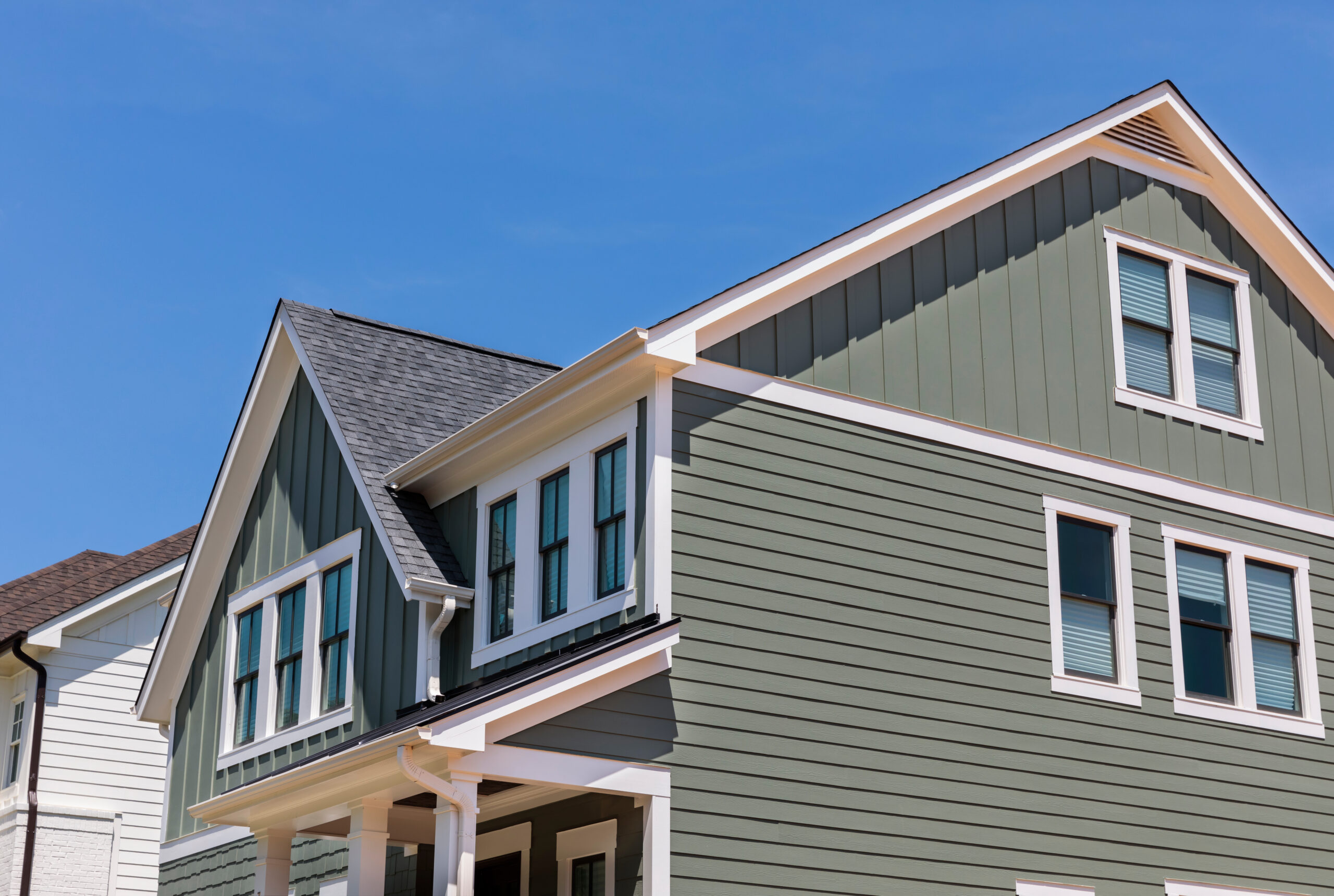 Dark green siding installed on home