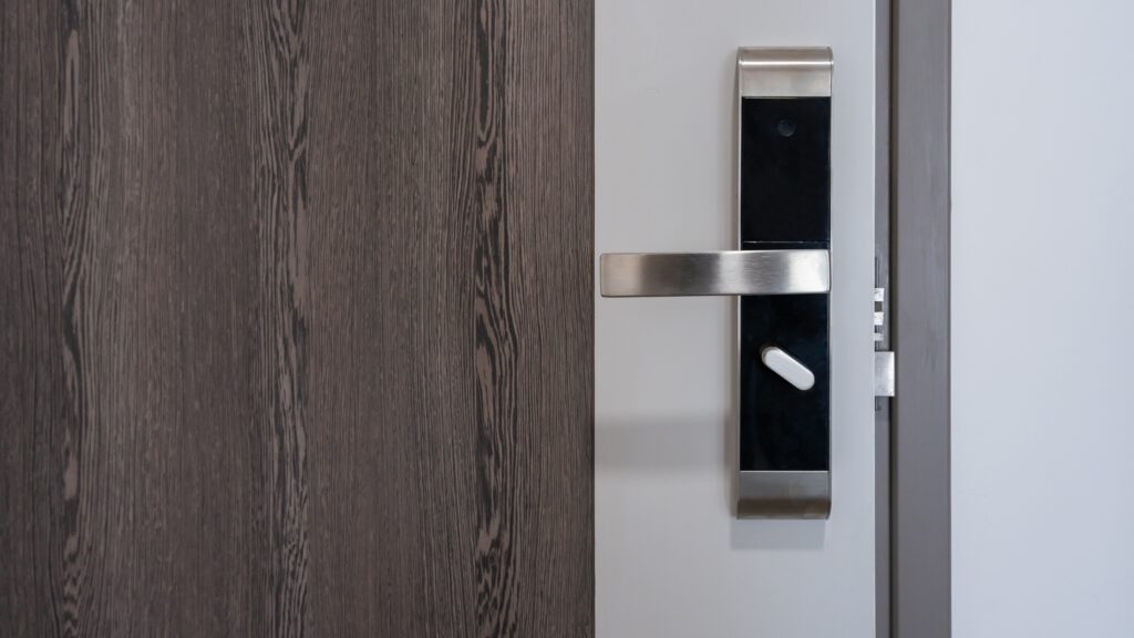 A close view of a modern front door equipped with a sleek handle and lock system