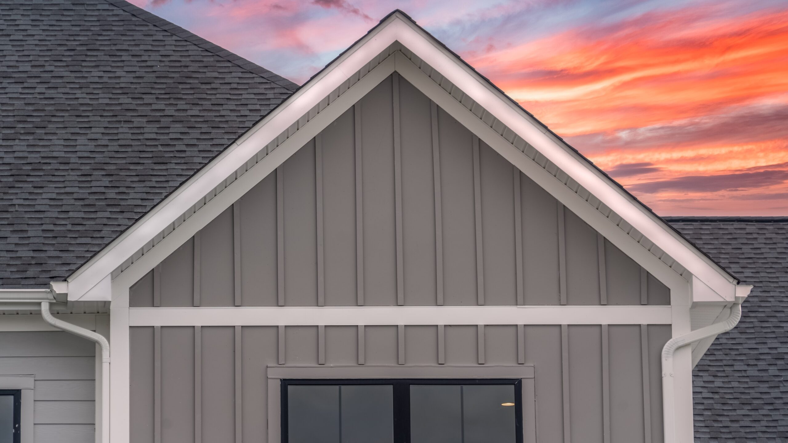 Close view of a siding-covered gable on a suburban home