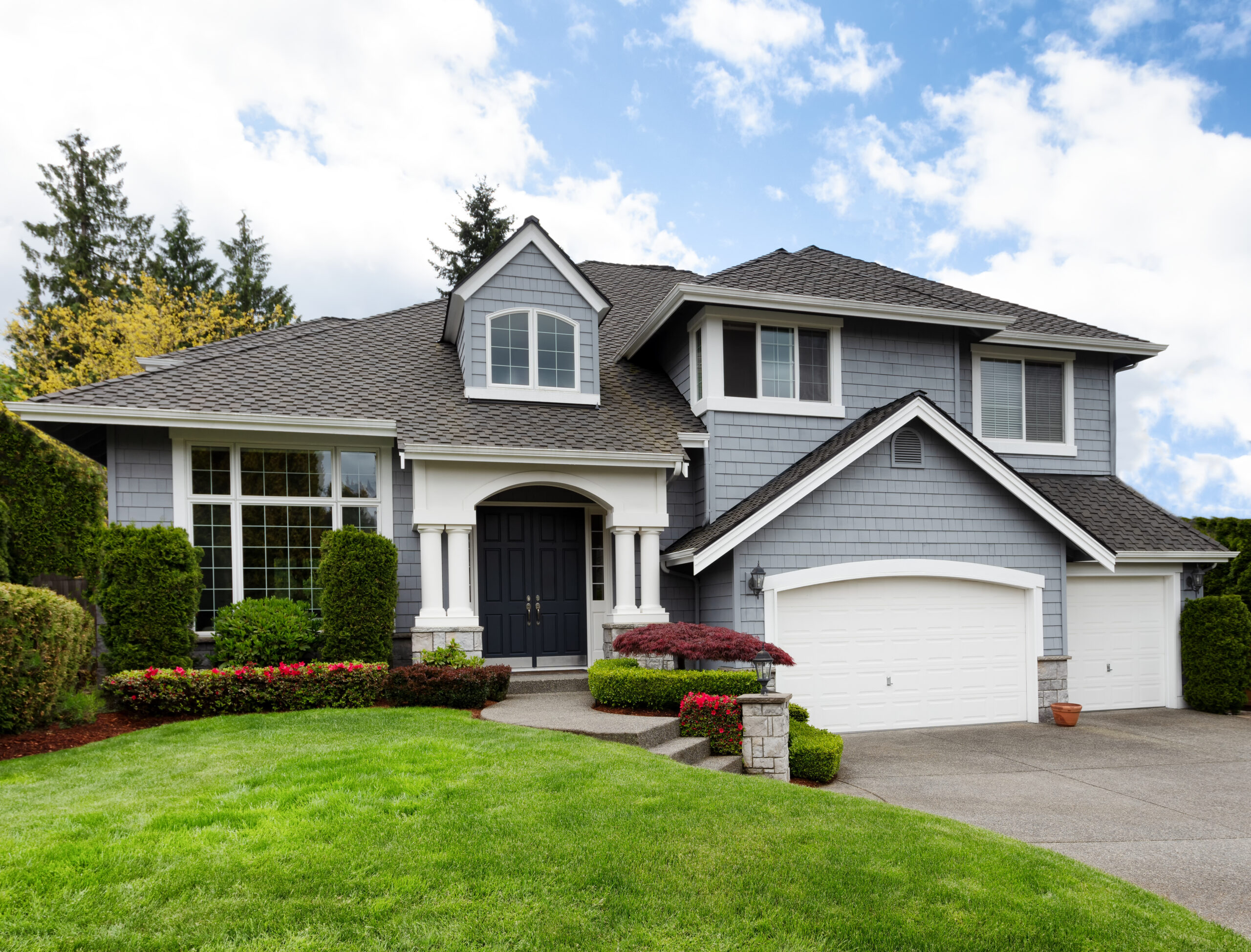 Beautiful home with light blue siding and gray roof