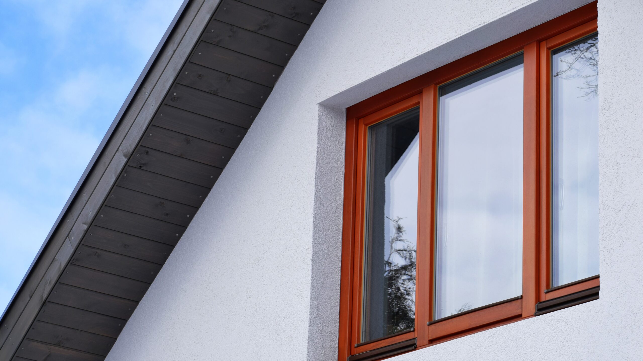 Close view of a bank of attractive windows on the second floor of a suburban home