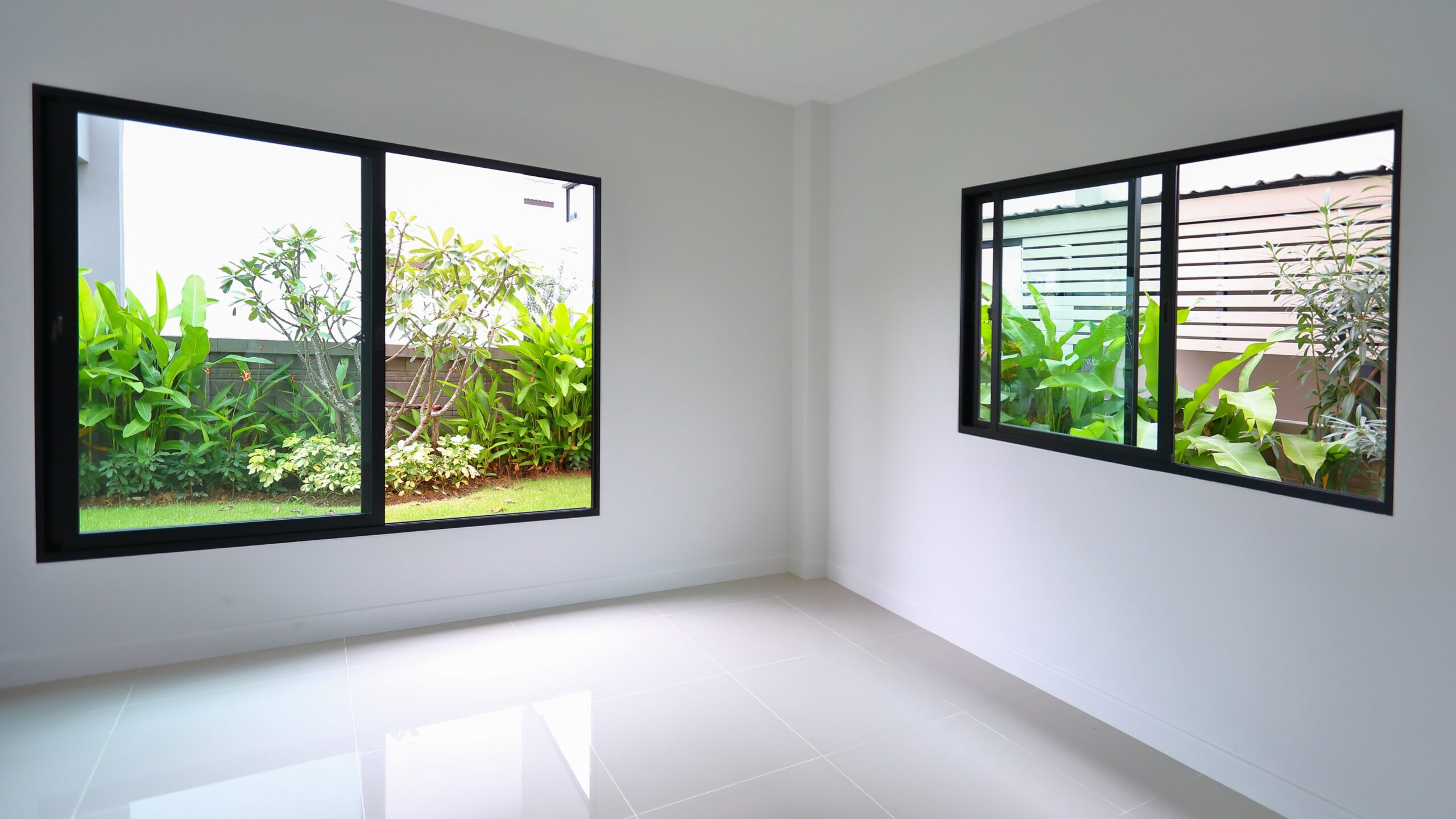 Angled view of the corner of a room with sliding windows installed on two walls