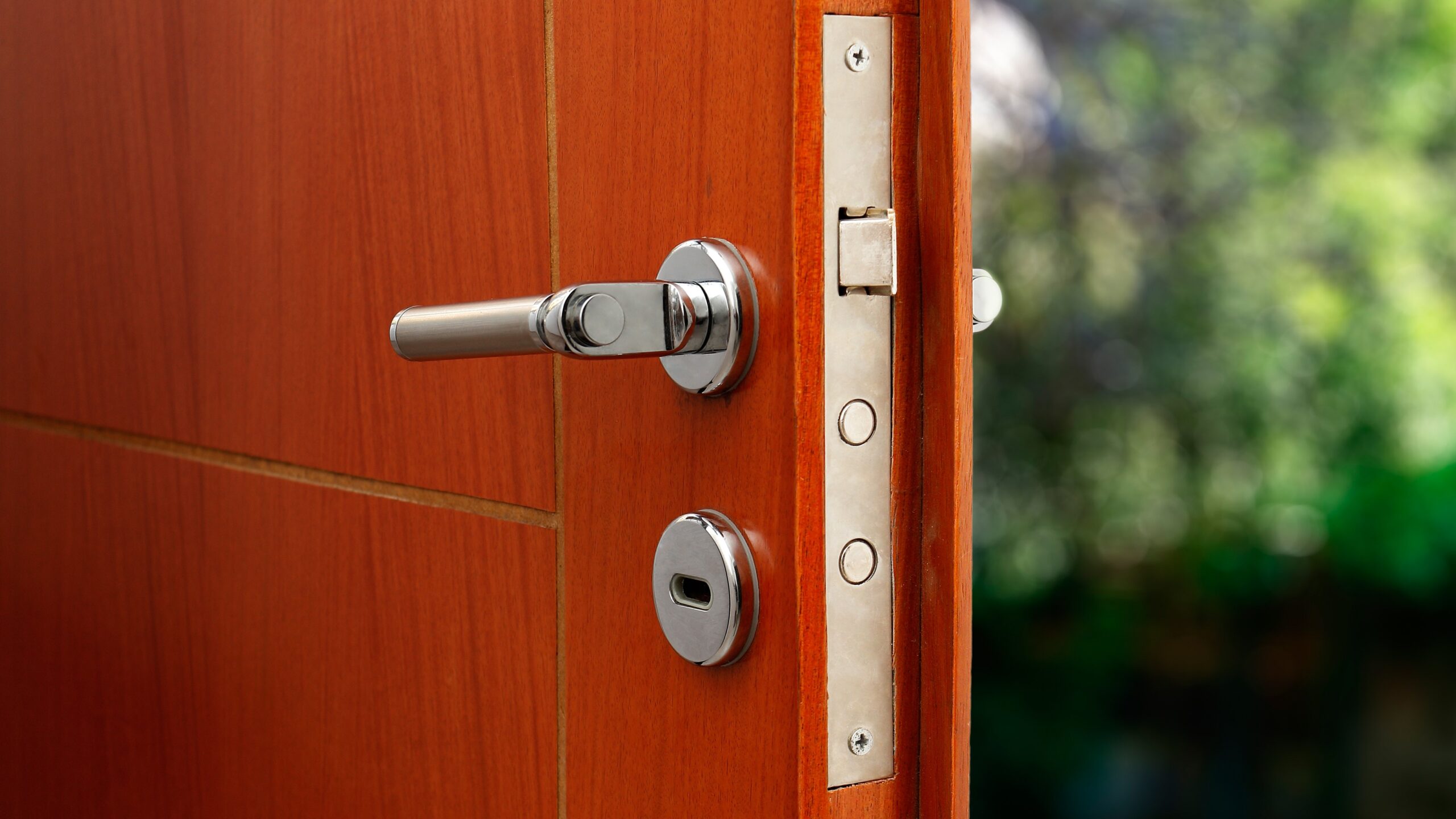 Close view of the locking mechanism on a modern wood front door with extra security features