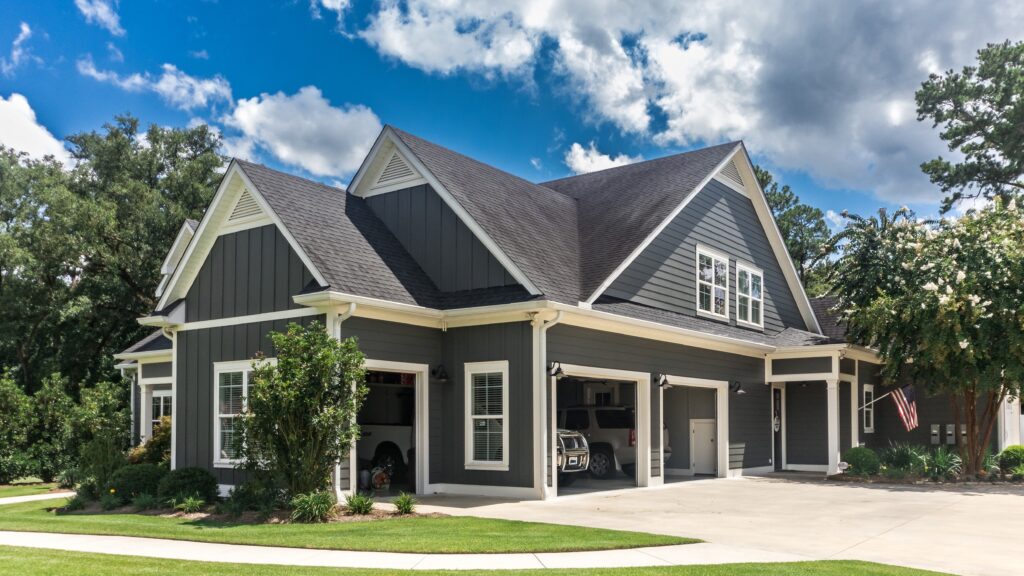 Angled view of a large, grey suburban home clad in James Hardie siding