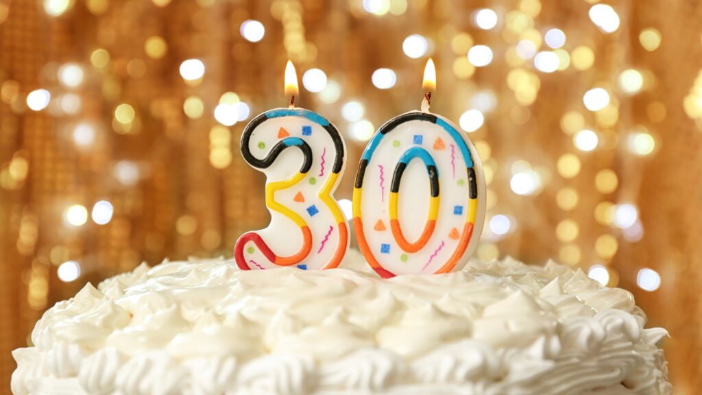 A celebratory cake with candles marking 30 years