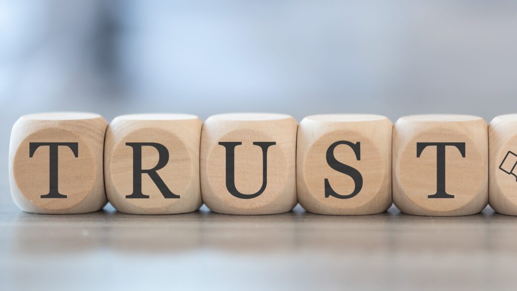 Blocks lined up to spell TRUST