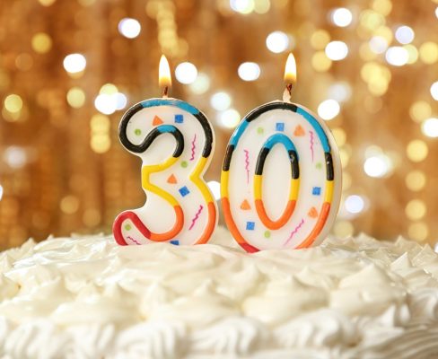 A celebratory cake with candles marking 30 years