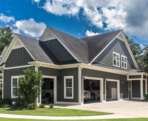 Angled view of a large, grey suburban home clad in James Hardie siding