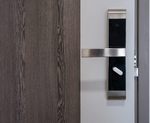 A close view of a modern front door equipped with a sleek handle and lock system