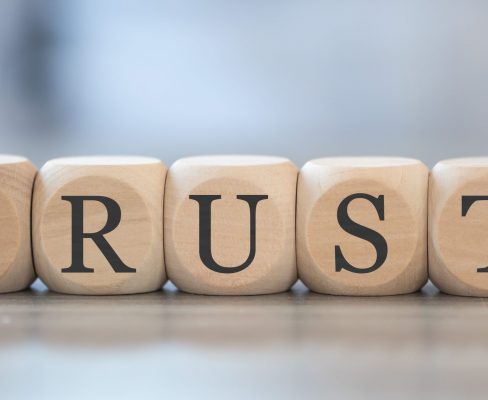 Blocks lined up to spell TRUST